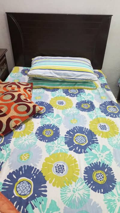 pair of single wooden beds