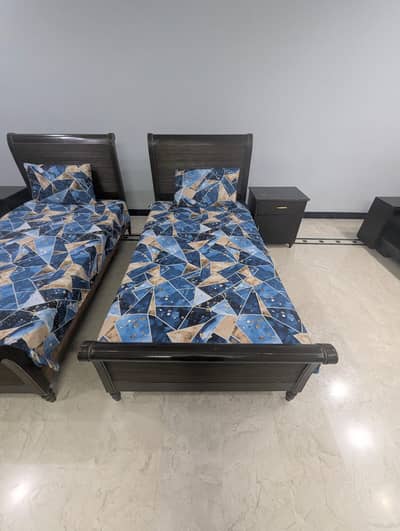 Set of single beds with  one side table each