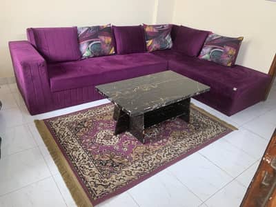 L-sofa with rug and centre table