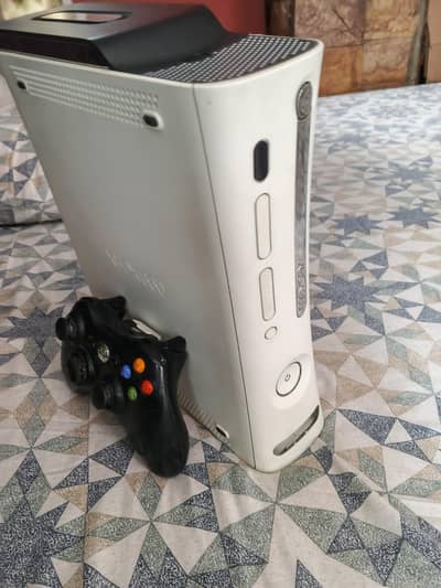 XBOX 360, 128 GB HDD with 30 plus games and 1 wireless controller.