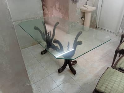 Glass top wooden base dining table