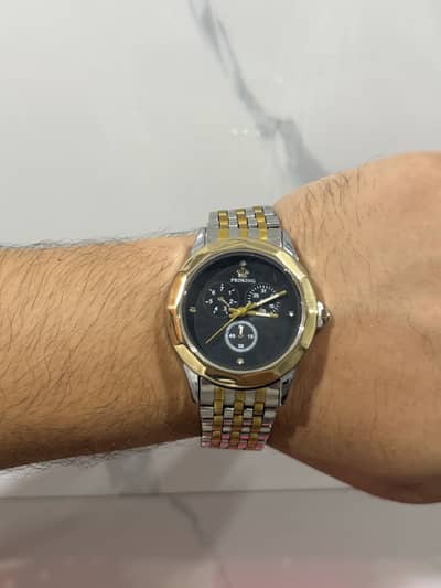 Golden and black watch