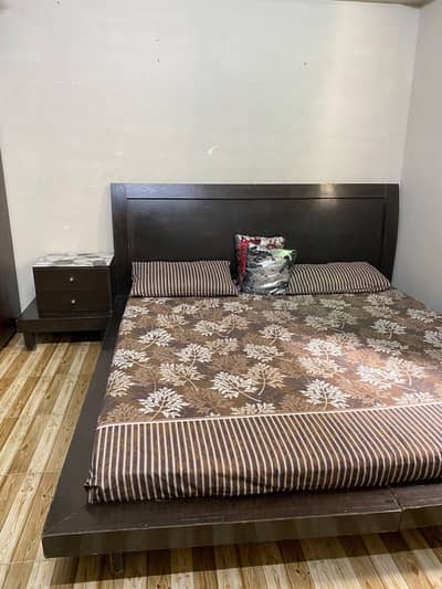 wooden king size bed with matching side tables and mirror for sale