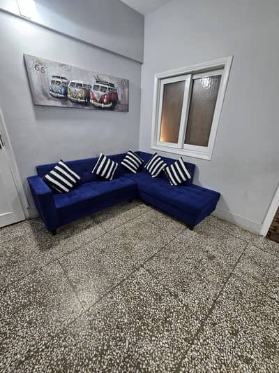 L shaped sofa in blue colour