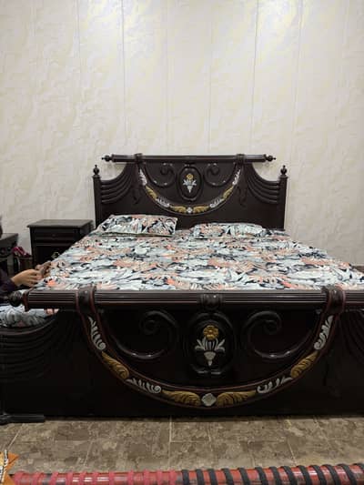 Bed, side table, mattress.