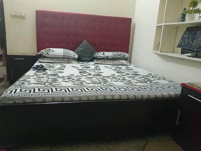 king side bed with two side table and two puffy