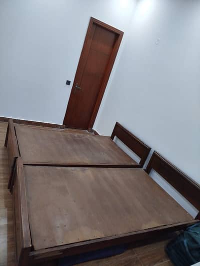 Two wooden single beds