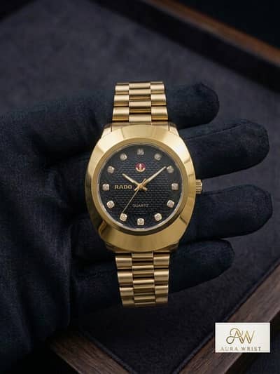 golden watch with black dial or crystal markers