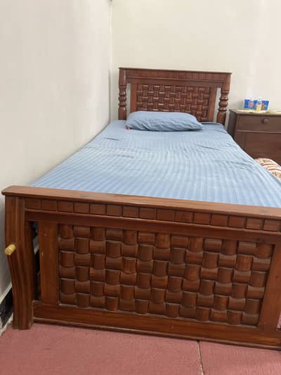 Two single bed with one side table.