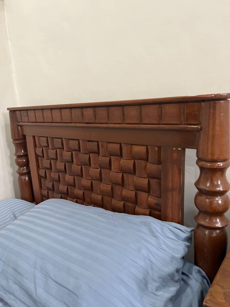 Two single bed with one side table. 1