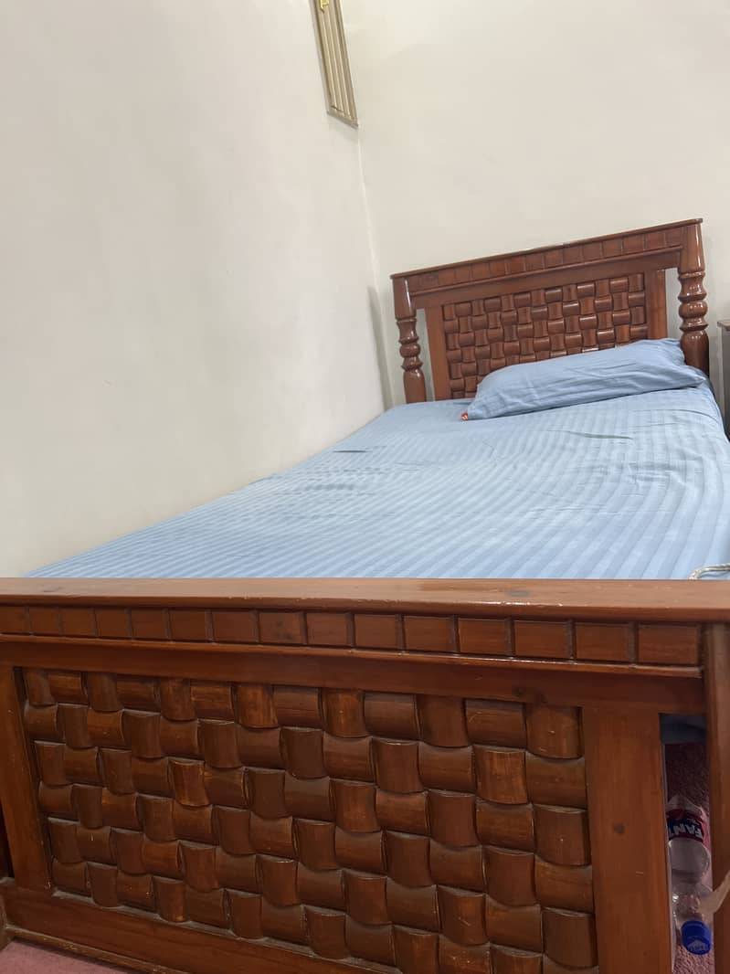 Two single bed with one side table. 2