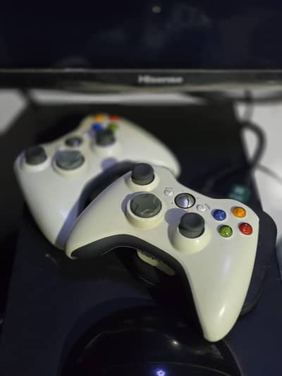 Xbox 360 with two controllers. All games  installed GTA V, and others.