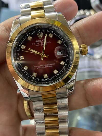 Rolex watch with black red and green dial