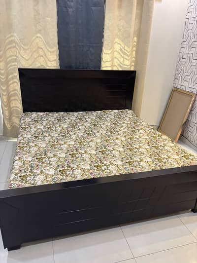 Wooden bed with side tables and mattress