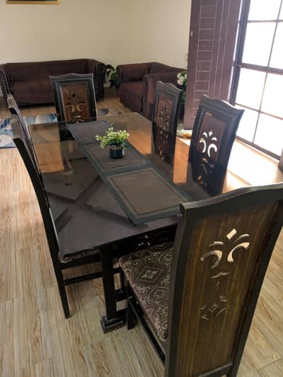 Wood dining table with glass top