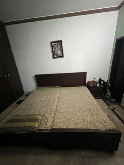 Used bed with one side table