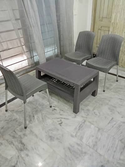 Boss plastic chairs. Quantity 3. And Boss center table.