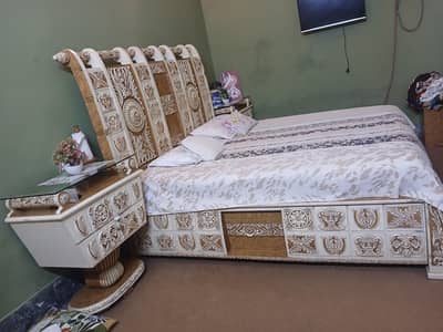 Bed with side table and dressing table