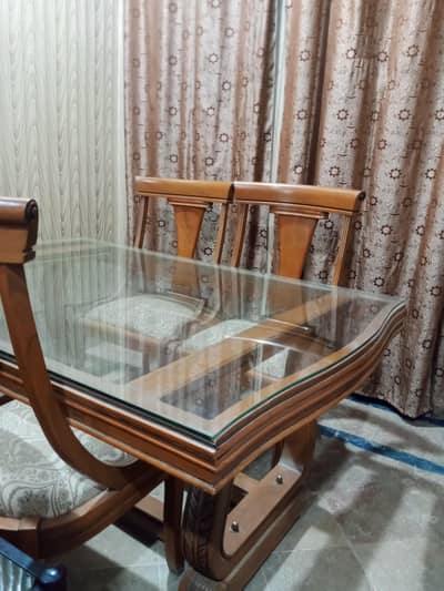 Stylish Dining table with glass covered table and 6 wooden chairs