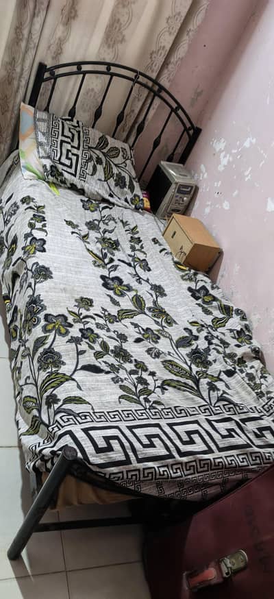 wrought iron bed, wooden divider and wooden 3 doors cupboard.