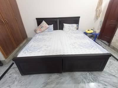 Two Single Wooden Beds