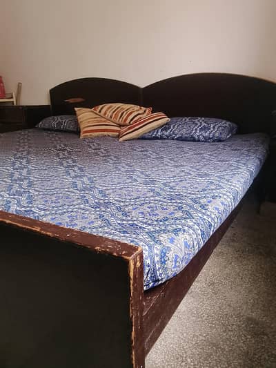 wooden single beds with side tables and mattress