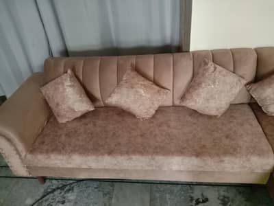 This is a new L-shaped designed sofa in velvet material .