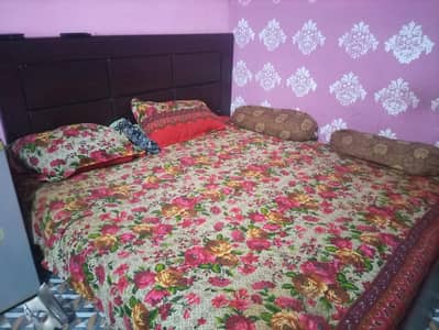 wooden double bed with mattress