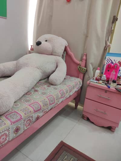 set of 2 wooden pink beds with side tables