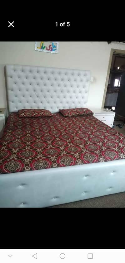 Bed with side tables, coffee chairs, dressing table