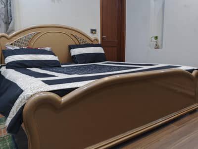 wooden bed and dressing table