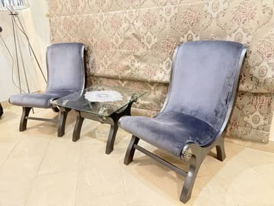 Two bedroom chairs with coffee table.