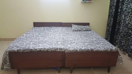 2 single wooden beds