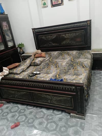 wooden bed with site table