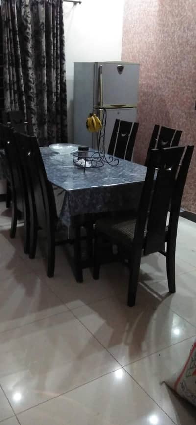wooden dinning table with glass top along with 6 chairs