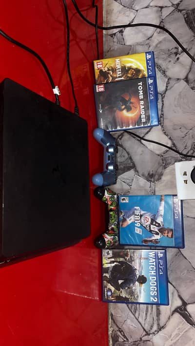 Ps4 slim 500 gb with 2 controllers and 4 games
