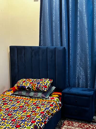 Two single bed sets with side tables