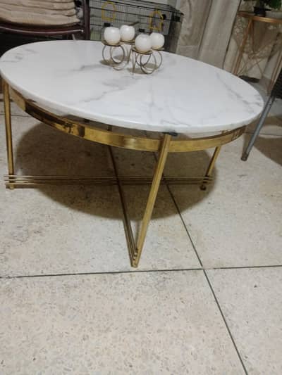 Center table with brass frame and heavy marble on it