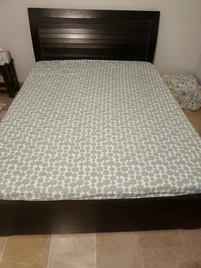 Queen-sized bed with mattress.