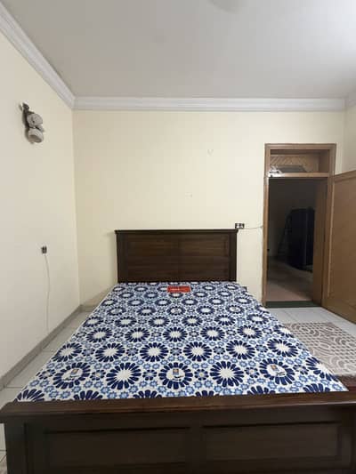 Wooden bed with mattress