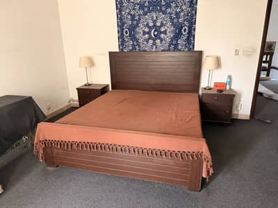 Queen size bed with mattress and side tables.