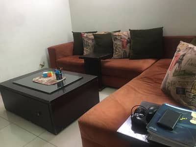 L-shaped sofa with center table and side tables