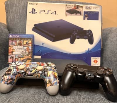 PlayStation 4 with two controllers and GTA 5
