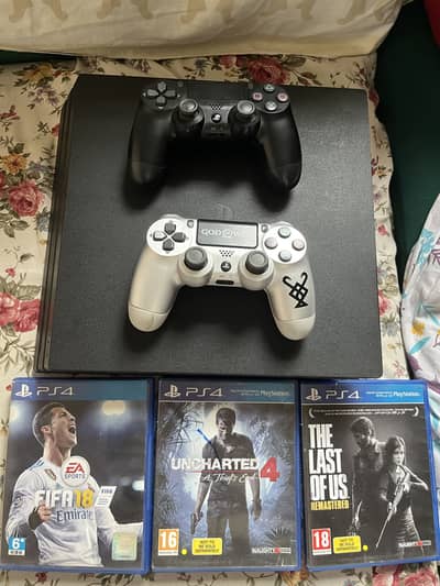 PS 4 PRO WITH GAMES AND CONTROLLERS