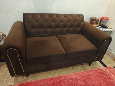 2 seater sofa with 2 cosions in almost new condition