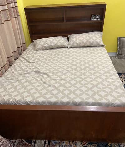 Wooden double bed with mattress