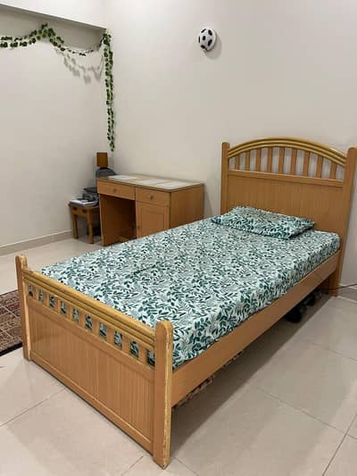 single bed without mattress awit h one side table and one study table