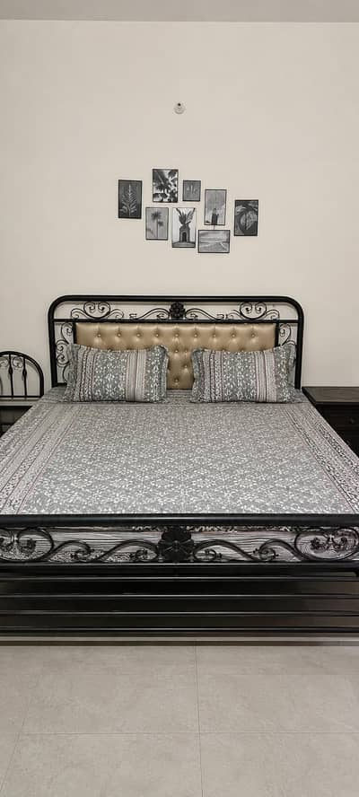 Double bed with spring mattress, side tables and dressing mirror