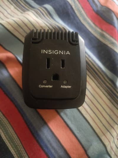 Black Insignia travel adapter and converter
