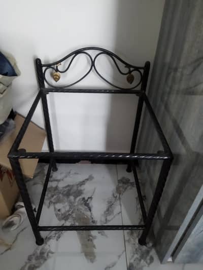 single bed with side table and matress.